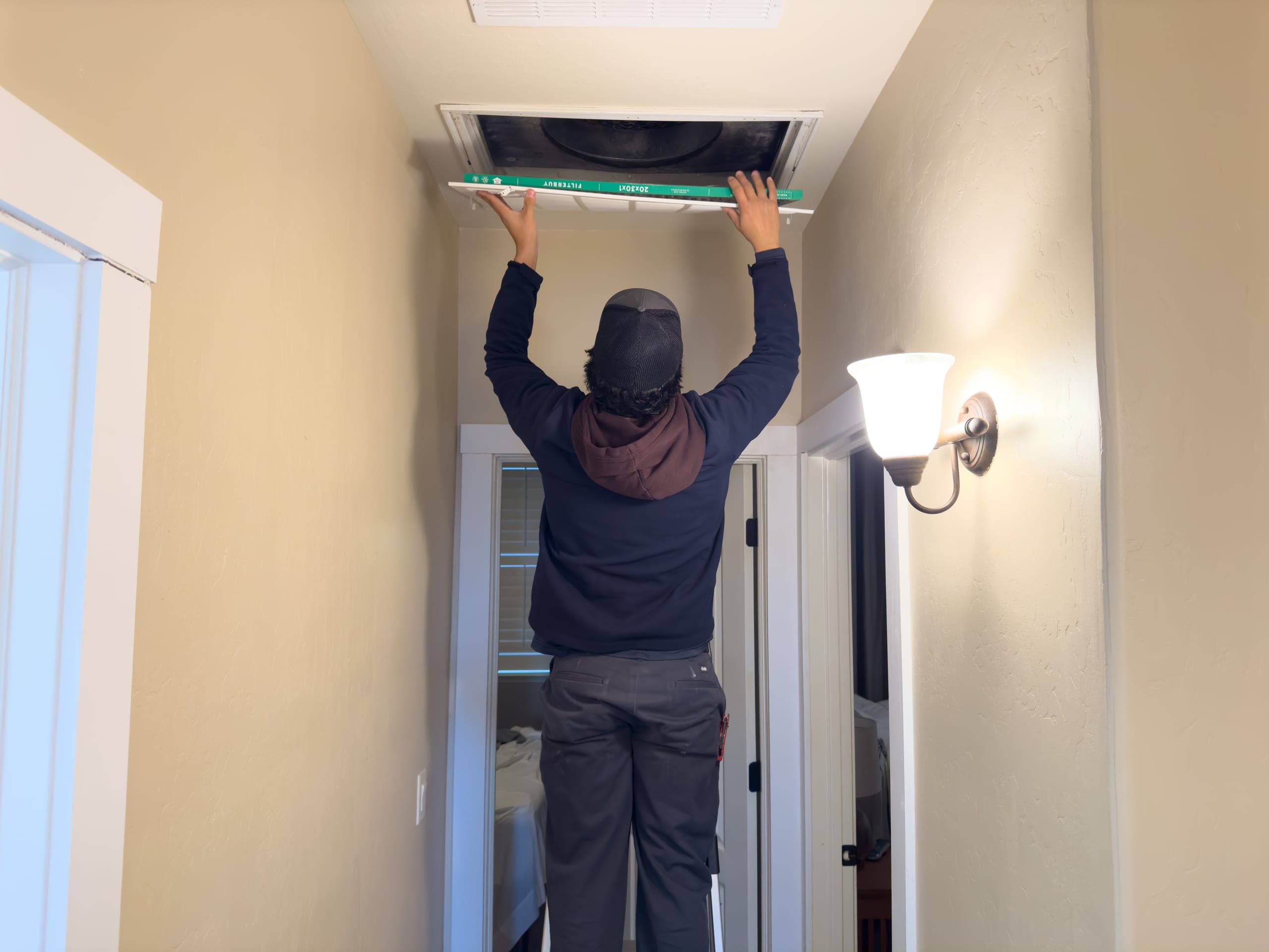Balanced Comfort technician replacing an air filter