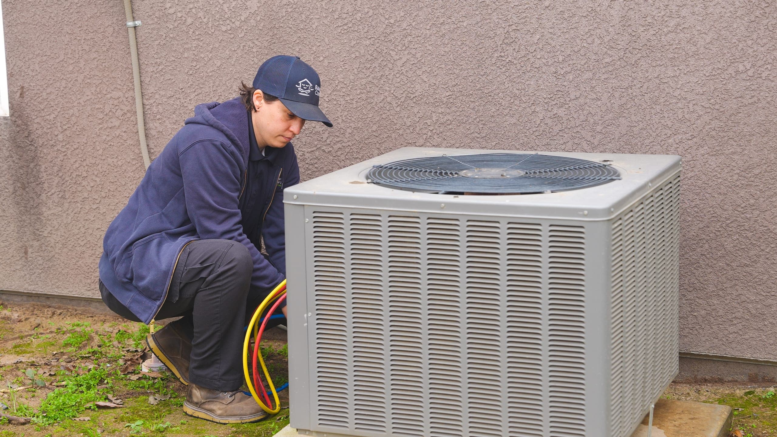 Balanced Comfort technician working on an AC unit