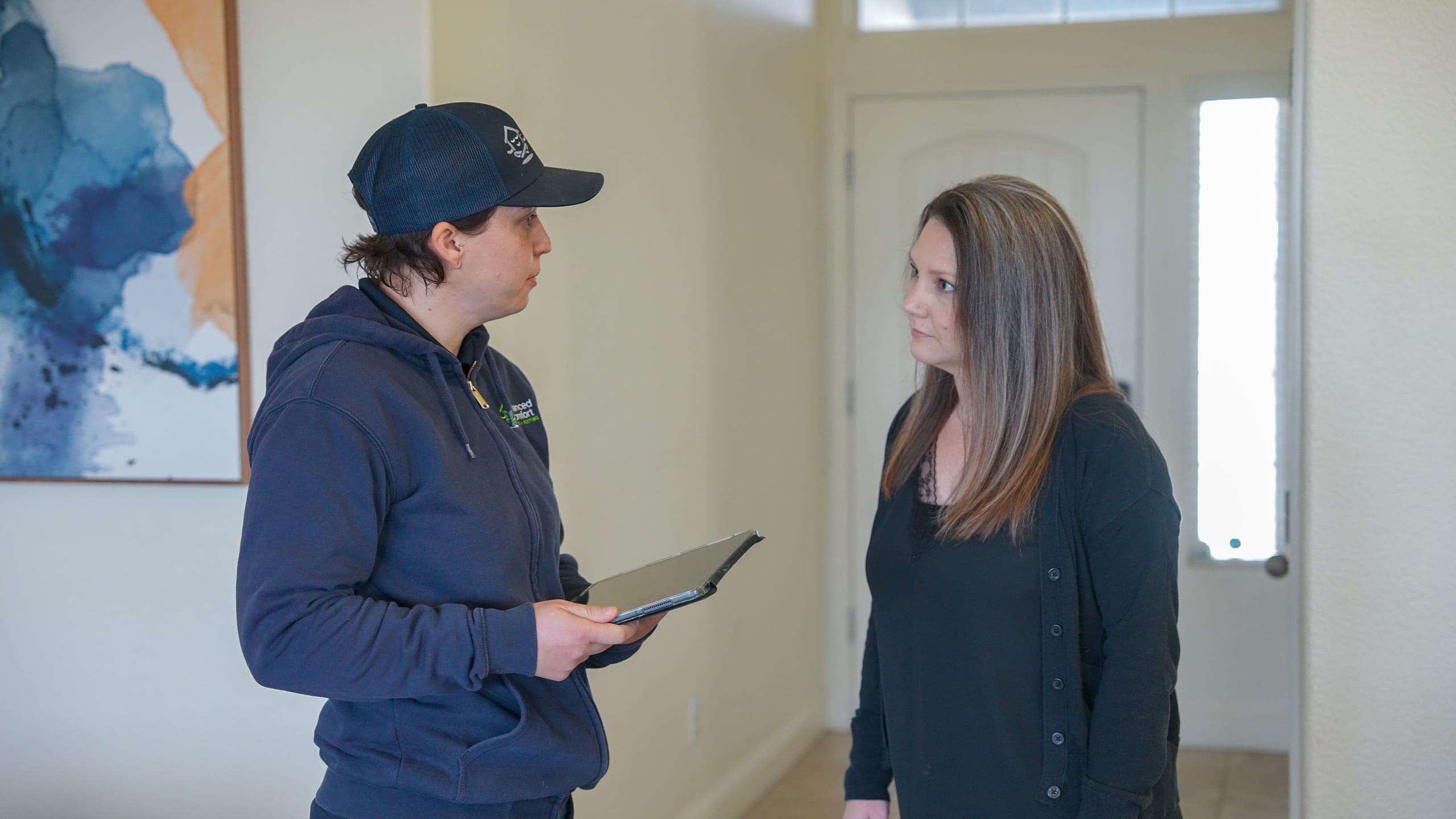 Balanced Comfort technician showing a homeowner the work